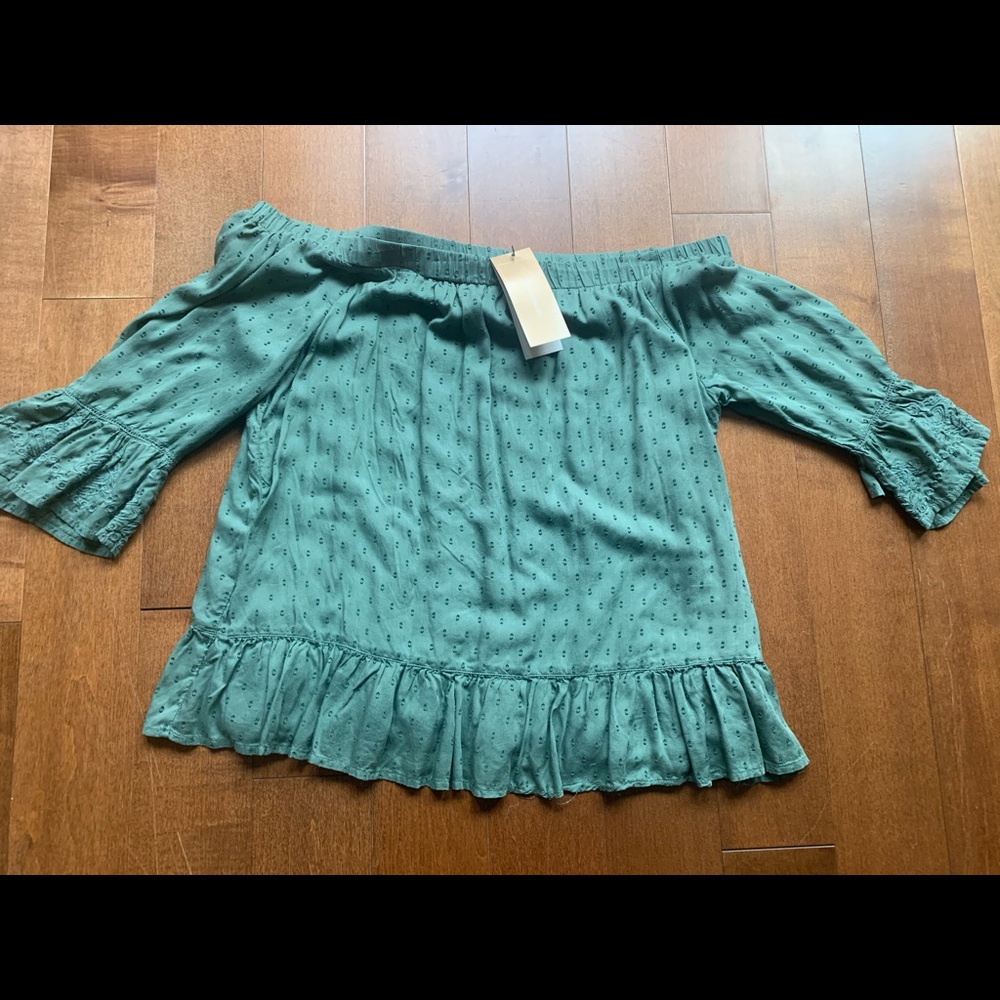 Green Francescas ruffle top with bell sleeves.